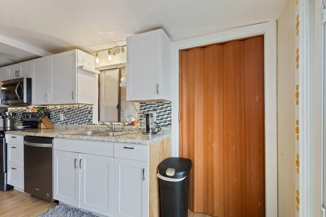 87-3216 Ama Rd, Captain Cook, HI 96704 - kitchen featuring appliances with stainless steel finishes, tasteful backsplash, and white cabinets