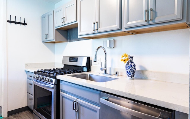 188 Hale St Unit 3C, Hilo, HI 96720 - kitchen with appliances with stainless steel finishes, a sink, dark wood-style floors, and light stone countertops