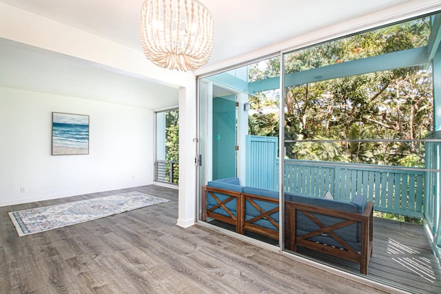 188 Hale St Unit 3C, Hilo, HI 96720 - doorway featuring a chandelier, wood finished floors, and baseboards
