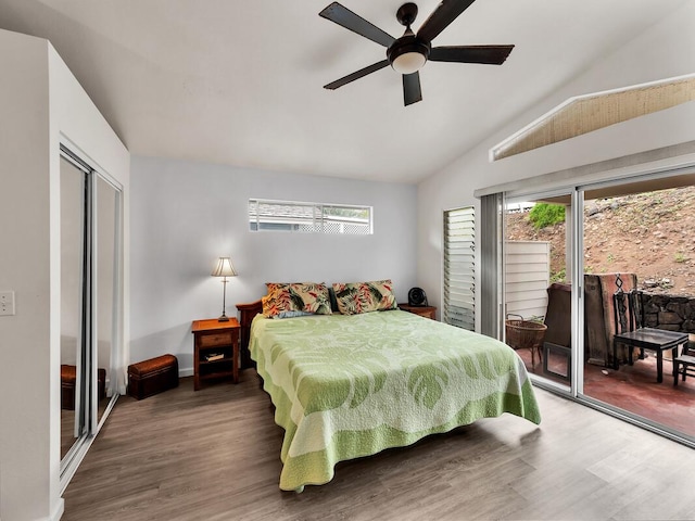 75-252 Nani Kailua Dr Unit 27, Kailua-Kona, HI 96740 - bedroom featuring access to outside, wood finished floors, multiple windows, vaulted ceiling, and baseboards