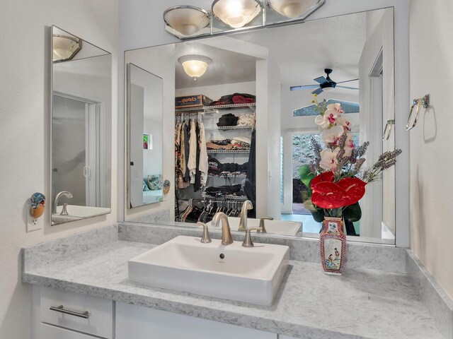 75-252 Nani Kailua Dr Unit 27, Kailua-Kona, HI 96740 - bathroom featuring vanity, ceiling fan, and a spacious closet