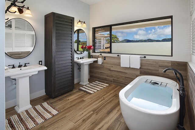 2750 Milo Hae Lp, Koloa, HI 96756 - full bathroom featuring a soaking tub, wood finished floors, and baseboards