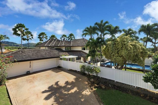 2750 Milo Hae Lp, Koloa, HI 96756 - view of property exterior featuring a garage and driveway