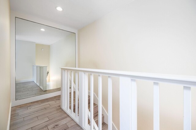 76-206 Kealoha St Unit 2A, Kailua-Kona, HI 96740 - corridor featuring wood finished floors, recessed lighting, and an upstairs landing