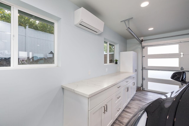 76-206 Kealoha St Unit 2A, Kailua-Kona, HI 96740 - workout room with an AC wall unit, recessed lighting, and light wood-type flooring
