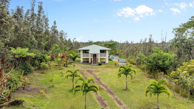 16-1580 39th Ave, Kurtistown, HI 96760 - view of grassy yard featuring a wooded view, stairs, and a wooden deck