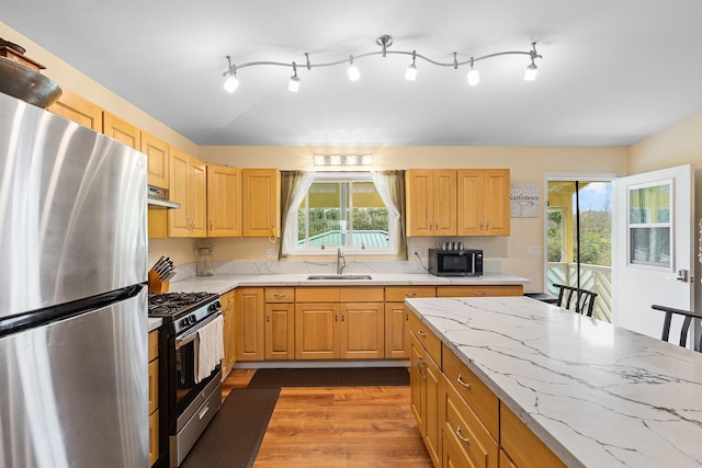 16-1580 39th Ave, Kurtistown, HI 96760 - kitchen featuring stainless steel appliances, a sink, wood finished floors, light stone counters, and under cabinet range hood