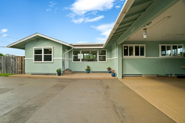 5587 Kawaihau Rd, Kapaa, HI 96746 - view of front of house featuring solar panels, stucco siding, and entry steps