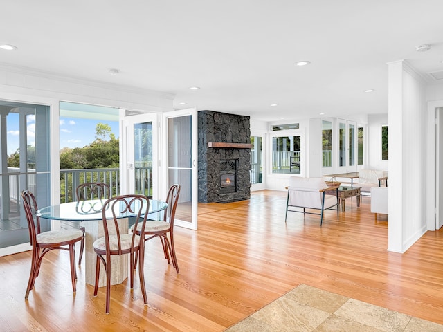 76-5807 Hookahi St Unit 1, Holualoa, HI 96725 - dining area with crown molding, a fireplace, light wood-style flooring, plenty of natural light, and recessed lighting