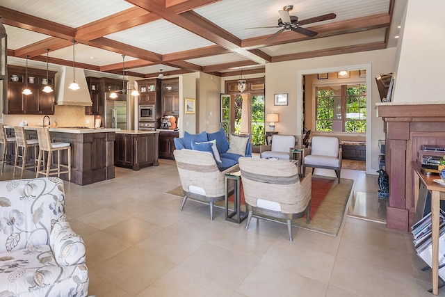 3661 Papalina Rd Unit A, Kalaheo, HI 96741 - living area featuring coffered ceiling, beam ceiling, ceiling fan, a fireplace, and light tile patterned flooring