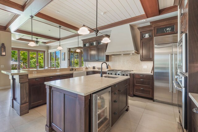 3661 Papalina Rd Unit A, Kalaheo, HI 96741 - kitchen with beverage cooler, stainless steel appliances, custom range hood, a sink, and an island with sink