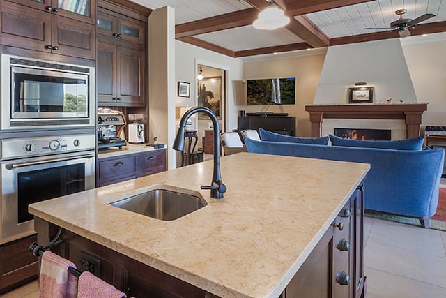 3661 Papalina Rd Unit A, Kalaheo, HI 96741 - kitchen featuring stainless steel appliances, a sink, ceiling fan, dark brown cabinetry, and beam ceiling