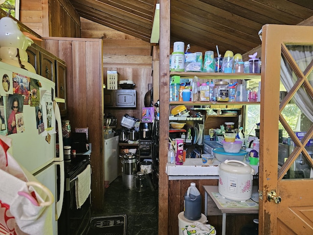 15-1483 28th Ave, Keaau, HI 96749 - interior space with freestanding refrigerator and wooden walls