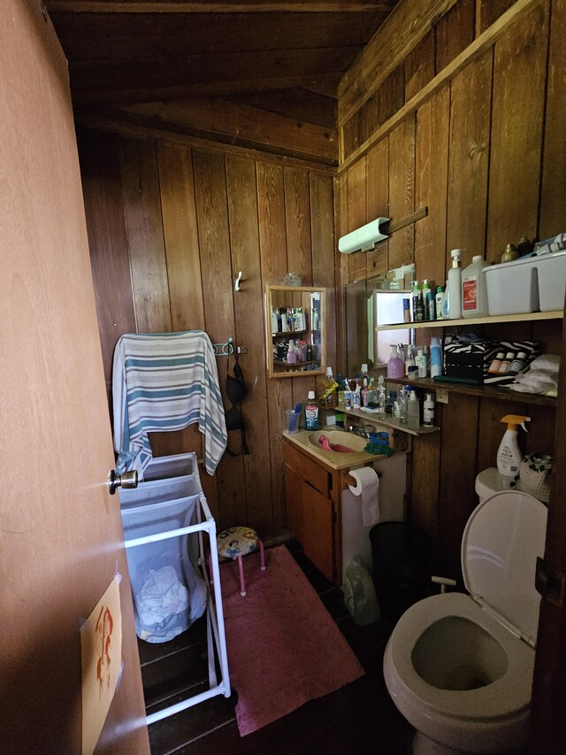 15-1483 28th Ave, Keaau, HI 96749 - kitchen featuring wood walls, brown cabinets, and a sink