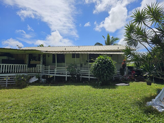 15-1483 28th Ave, Keaau, HI 96749 - back of property with a lawn, metal roof, and a porch