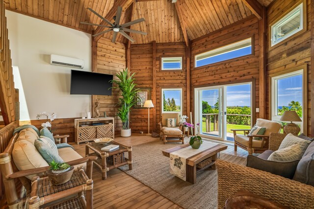 5421-C Kalalea View Dr, Anahola, HI 96703 - living area featuring healthy amount of natural light, high vaulted ceiling, an AC wall unit, a ceiling fan, and wood walls