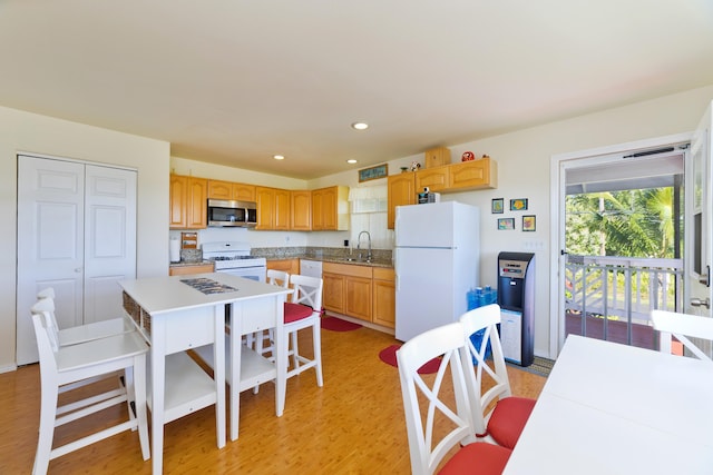 12-7042 Wehelauniu St, Pahoa, HI 96778 - kitchen with white appliances, a sink, light wood-style flooring, recessed lighting, and a kitchen island