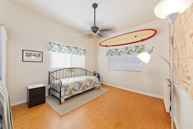 12-7042 Wehelauniu St, Pahoa, HI 96778 - bedroom with wood finished floors, baseboards, a ceiling fan, and radiator heating unit