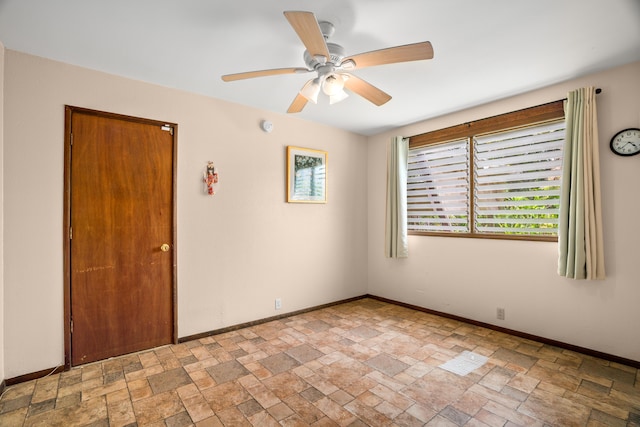 187 Lihau St, Kapaa, HI 96746 - empty room featuring light stone finish floors, a ceiling fan, and baseboards