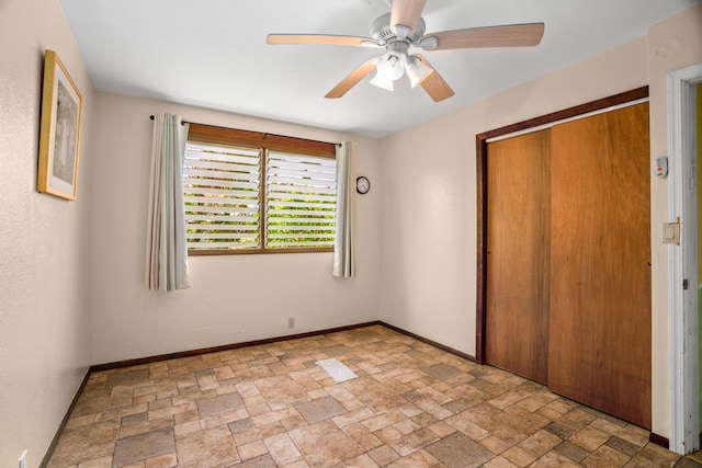 187 Lihau St, Kapaa, HI 96746 - unfurnished bedroom featuring stone finish floors, baseboards, a closet, and a ceiling fan