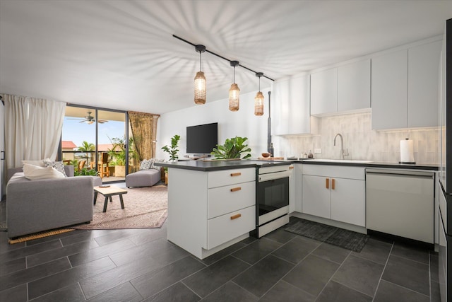 75-5865 Walua Rd Unit D624, Kailua-Kona, HI 96740 - kitchen with open floor plan, dishwashing machine, a sink, a peninsula, and white cabinetry