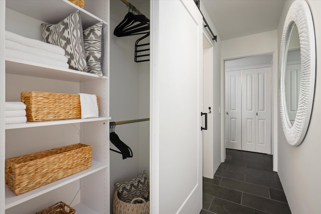 75-5865 Walua Rd Unit D624, Kailua-Kona, HI 96740 - corridor with a barn door and dark tile patterned floors