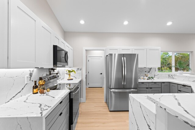 15-2026 20th Ave, Keaau, HI 96749 - kitchen with stainless steel appliances, light stone countertops, light wood finished floors, backsplash, and recessed lighting