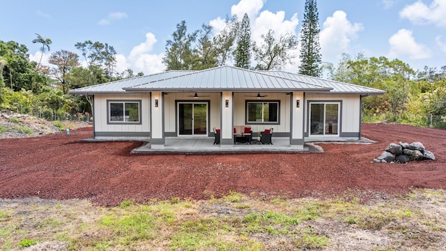 15-2026 20th Ave, Keaau, HI 96749 - rear view of house featuring ceiling fan, a patio, an outdoor hangout area, board and batten siding, and metal roof