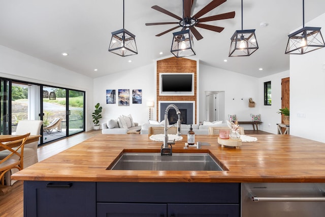 71-1871 Puu Lani Loop, Kailua-Kona, HI 96740 - kitchen with butcher block counters, open floor plan, ceiling fan, a kitchen island with sink, and hanging light fixtures