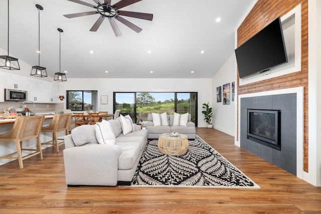 71-1871 Puu Lani Loop, Kailua-Kona, HI 96740 - living area featuring high vaulted ceiling, a ceiling fan, recessed lighting, light wood-style floors, and a tiled fireplace