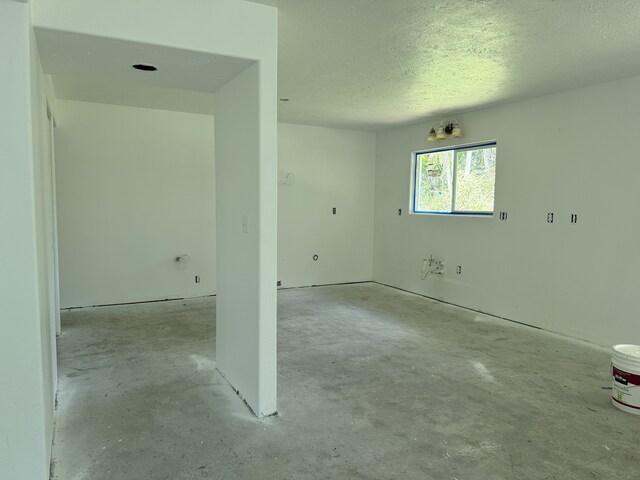 13-3436 Alapai St, Pahoa, HI 96778 - unfurnished room featuring concrete flooring and a textured ceiling