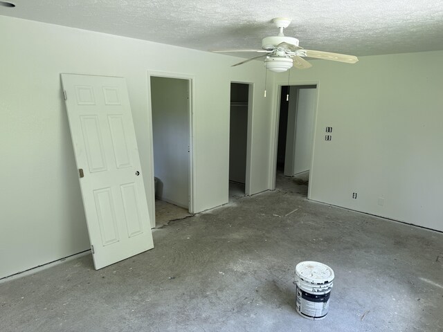 13-3436 Alapai St, Pahoa, HI 96778 - unfurnished bedroom with a textured ceiling and a ceiling fan