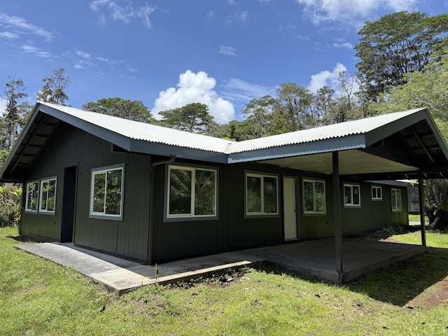 13-3436 Alapai St, Pahoa, HI 96778 - rear view of house featuring a yard, a patio area, and metal roof