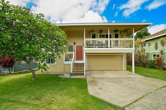 5167 Holomua Pl, Kapaa, HI 96746 - view of front of home with a garage, a front yard, driveway, and a porch