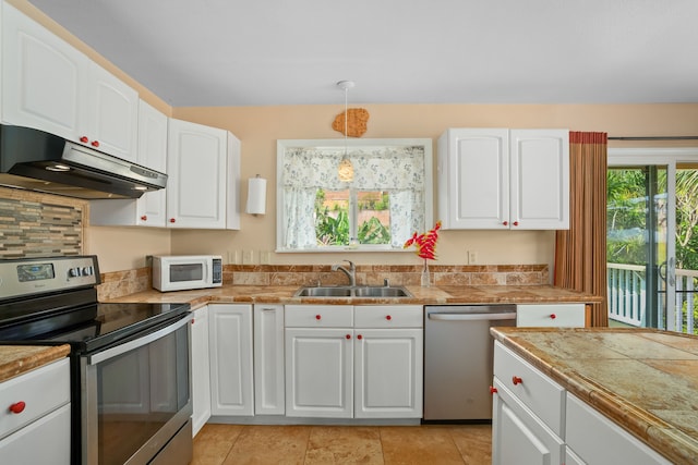 5167 Holomua Pl, Kapaa, HI 96746 - kitchen featuring appliances with stainless steel finishes, under cabinet range hood, a sink, and white cabinets