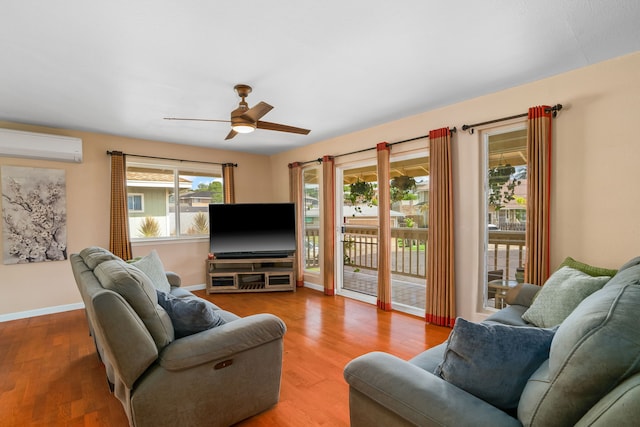 5167 Holomua Pl, Kapaa, HI 96746 - living room featuring an AC wall unit, a ceiling fan, wood finished floors, and baseboards