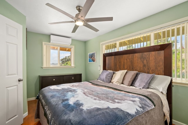 5167 Holomua Pl, Kapaa, HI 96746 - bedroom with an AC wall unit, baseboards, wood finished floors, and ceiling fan