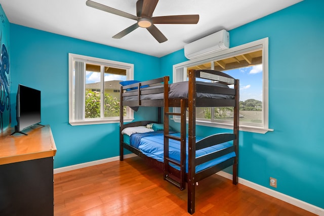 5167 Holomua Pl, Kapaa, HI 96746 - bedroom with an AC wall unit, wood finished floors, baseboards, and a ceiling fan