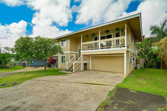 5167 Holomua Pl, Kapaa, HI 96746 - view of front facade featuring a garage, driveway, a front lawn, and cooling unit