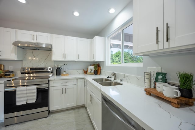 15-1791 4th Ave, Keaau, HI 96749 - kitchen with under cabinet range hood, appliances with stainless steel finishes, a sink, white cabinets, and light stone countertops
