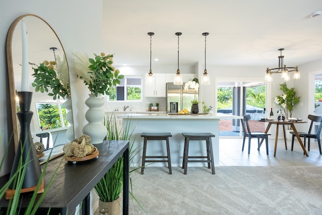 15-1791 4th Ave, Keaau, HI 96749 - kitchen featuring stainless steel refrigerator with ice dispenser, light countertops, white cabinets, a chandelier, and hanging light fixtures