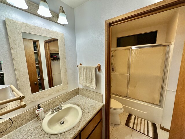 15-2772 Maikoiko St, Pahoa, HI 96778 - full bath with vanity, toilet, tile patterned floors, combined bath / shower with glass door, and a textured wall
