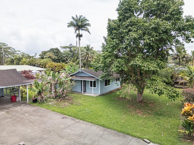 15-2755 Akule St, Pahoa, HI 96778 - view of front of property with a front yard, driveway, roof with shingles, and a carport