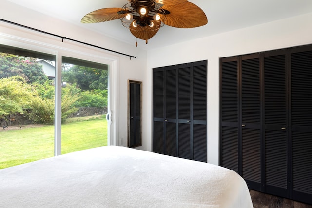 75-5811 Nani Kailua Pl, Kailua-Kona, HI 96740 - unfurnished bedroom with multiple closets, dark wood-style floors, and a ceiling fan
