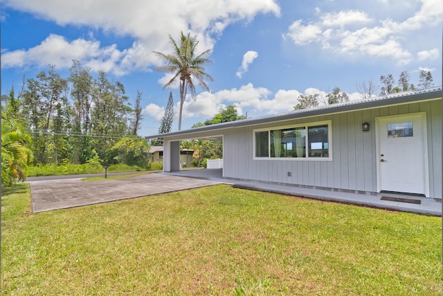 15-2804 Maikoiko St, Pahoa, HI 96778 - view of front of property with an attached carport, concrete driveway, a front lawn, and metal roof