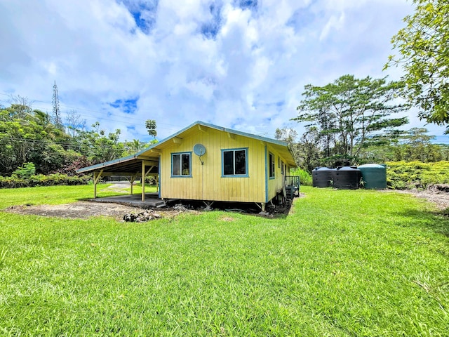 13-3403 Kumakahi St, Pahoa, HI 96778 - view of side of home with an attached carport and a yard