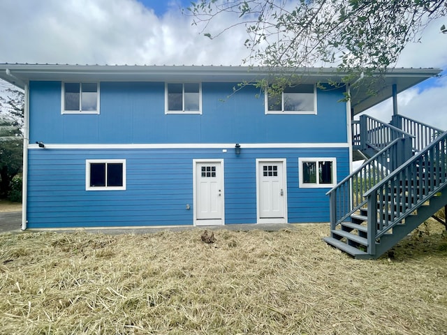 94-6707 Kamaoa Rd, Naalehu, HI 96772 - rear view of property with metal roof, stairs, and a yard