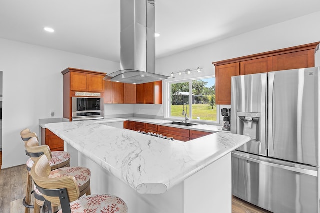 16-2028 35th Ave, Keaau, HI 96749 - kitchen with appliances with stainless steel finishes, island exhaust hood, a sink, light wood-style floors, and a center island