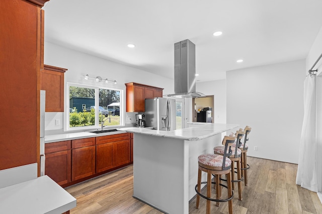16-2028 35th Ave, Keaau, HI 96749 - kitchen featuring stainless steel refrigerator with ice dispenser, a sink, island range hood, light countertops, and light wood-style floors