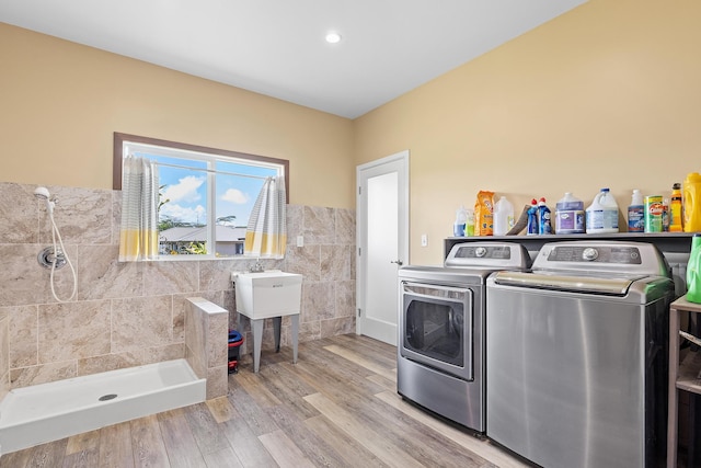 16-2028 35th Ave, Keaau, HI 96749 - laundry area with washer and dryer, tile walls, wainscoting, and light wood finished floors